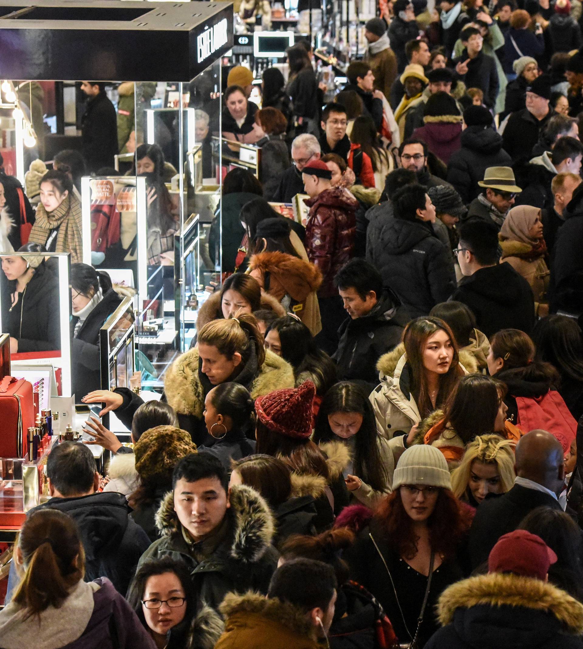 A large crowd of people shop during a Black Friday sales event at Macy's flagship store in New York City