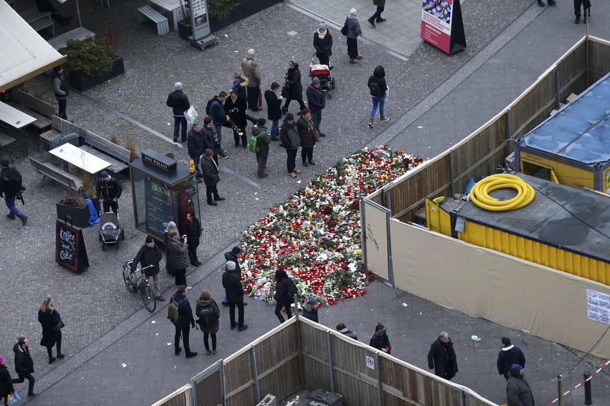 Flowers and candles are placed near the Christmas market in Berlin