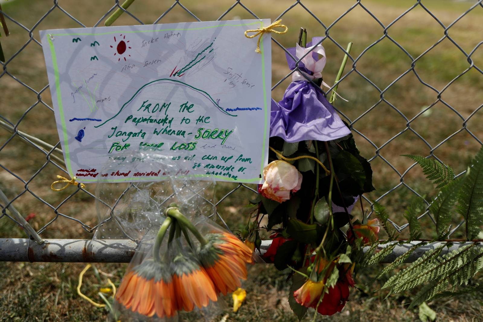 A note of condolence is seen at a memorial at the harbour in Whakatane, following the White Island volcano eruption in New Zealand
