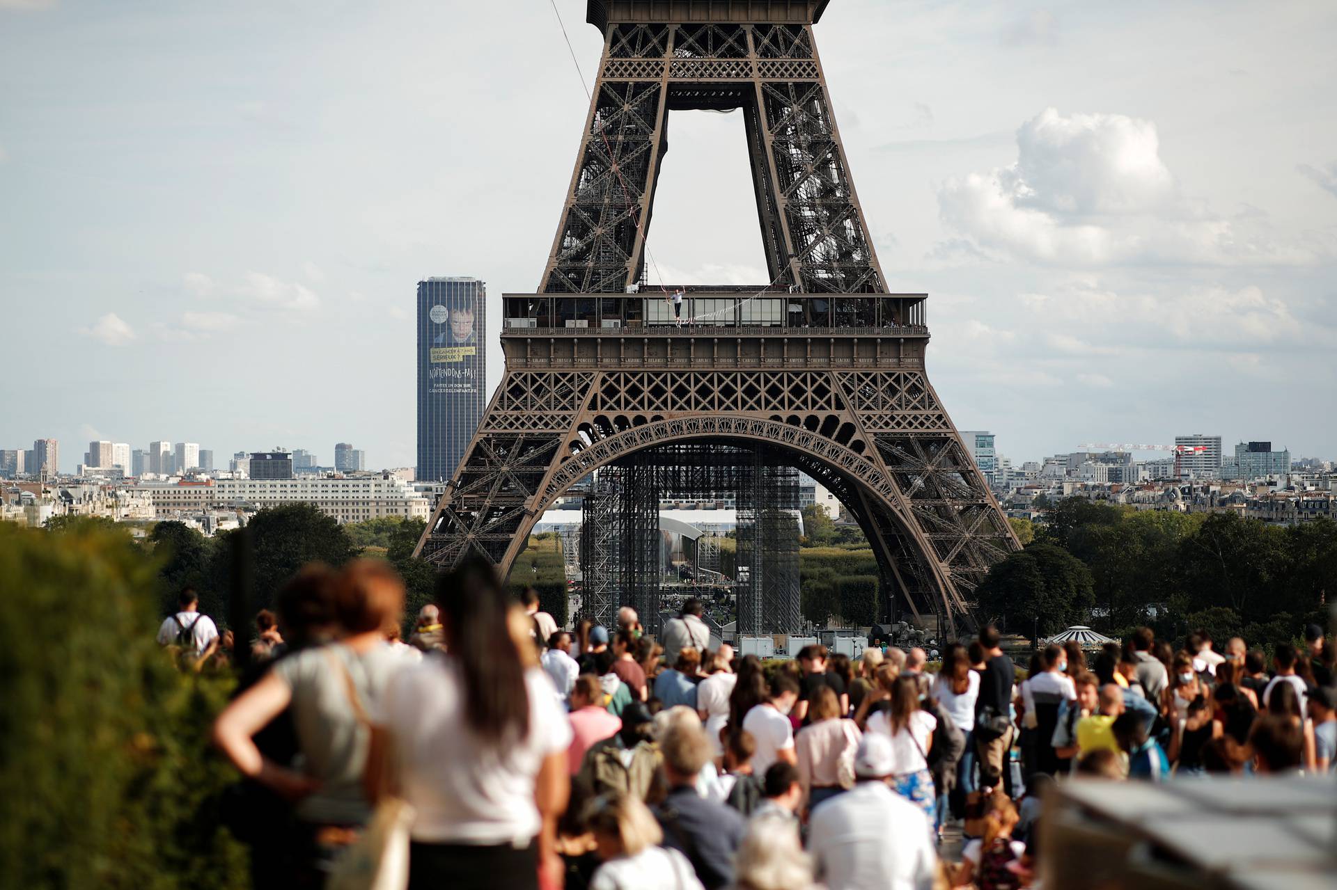 French acrobat Nathan Paulin walks on a slackline between the Eiffel Tower and the Theatre National de Chaillot as part of events around France for National Heritage Day