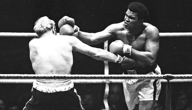 Muhammad Ali punches Richard Dunn while fighting for the WBC & WBA Heavyweight Title in Munich