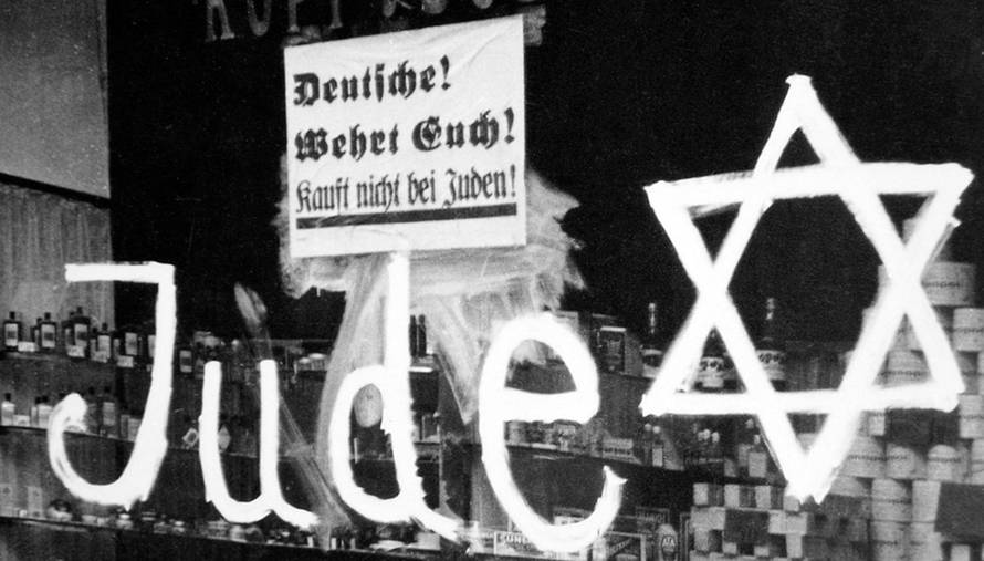 Germany: A Jewish-owned shop vandalized by Nazis with poster reading 'Germans Defend Yourselves - Don't Buy from Jews', 1938