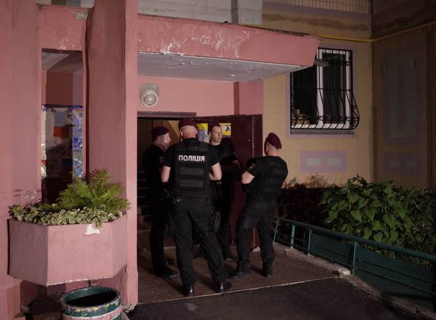 Ukrainian police officers guard in the entrance to a house where Russian journalist Babchenko was shot and died of his wounds in an ambulance, in Kiev