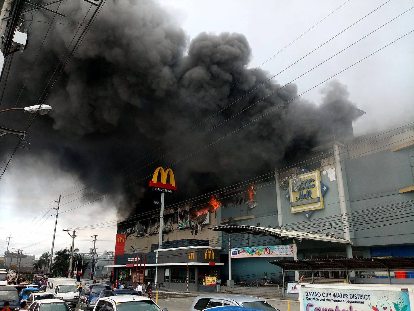 Smoke billows from a shopping mall on fire in Davao City