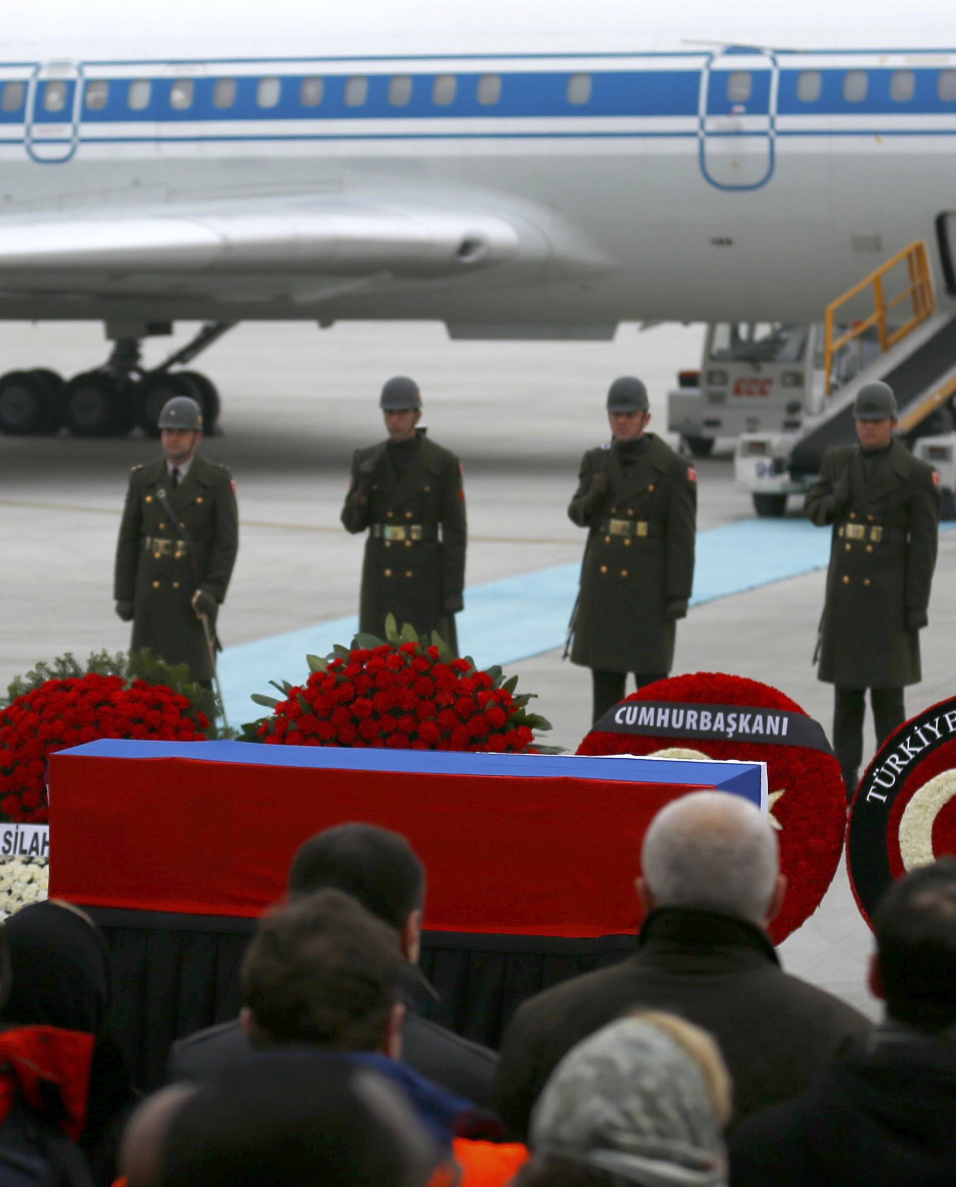 Flag-wrapped coffin of late Russian Ambassador to Turkey Karlov is carried to a plane during a ceremony at Esenboga airport in Ankara
