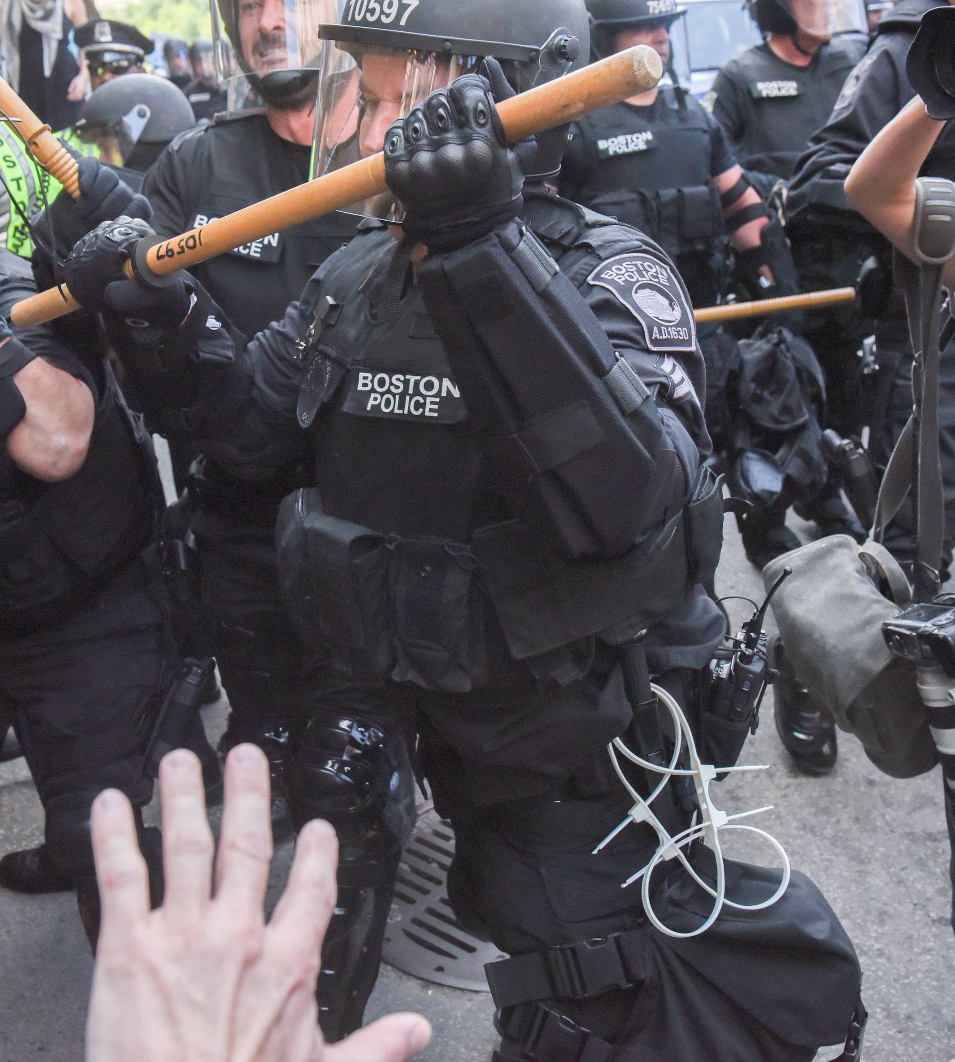 Boston Police officers react as a crowd of counter protesters clashes with them outside of the Boston Commons and the Boston Free Speech Rally in Boston, Massachusetts