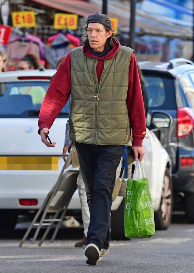 *EXCLUSIVE* Christopher Brosnan is spotted on a stroll holding his Waitrose bag out shopping on the Portobello Road in London's Notting Hill.