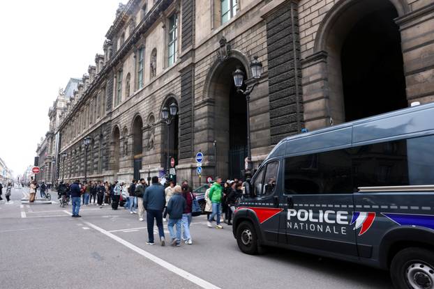 Police vehicle stands near the entrance to the Louvre museum after reports of a robbery, in Paris