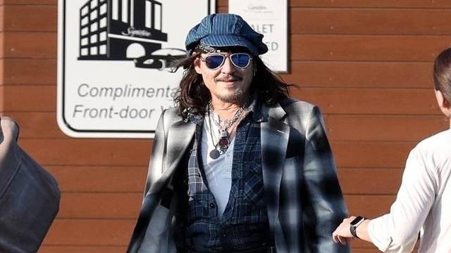 *EXCLUSIVE* Johnny Depp uses a cane while arriving in Boston for his Hollywood Vampires show after being forced to reschedule due to ankle fracture.