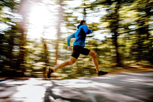 blurred motion male athlete runner