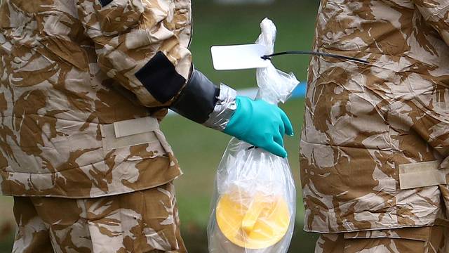 FILE PHOTO: People in military hazardous material protective suits collect an item in Queen Elizabeth Gardens in Salisbury