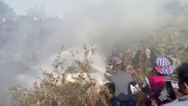 Rescuers work at the site of a plane crash in Pokhara