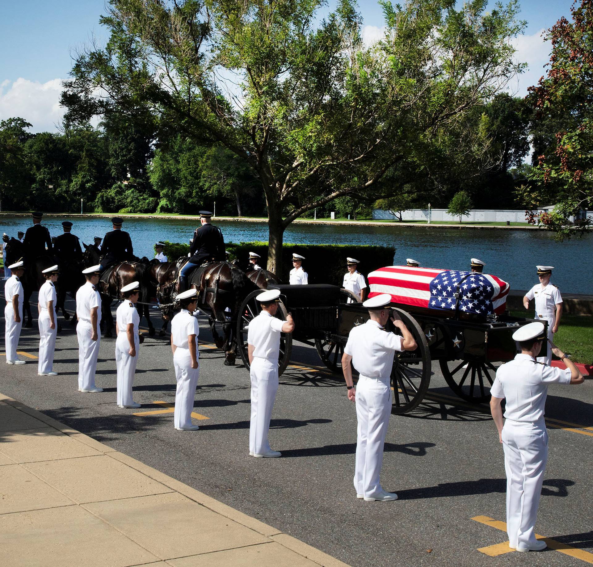 The horse-drawn caisson bearing the body of Sen. McCain moves through the grounds of the United Sates Naval Academy in Annapolis