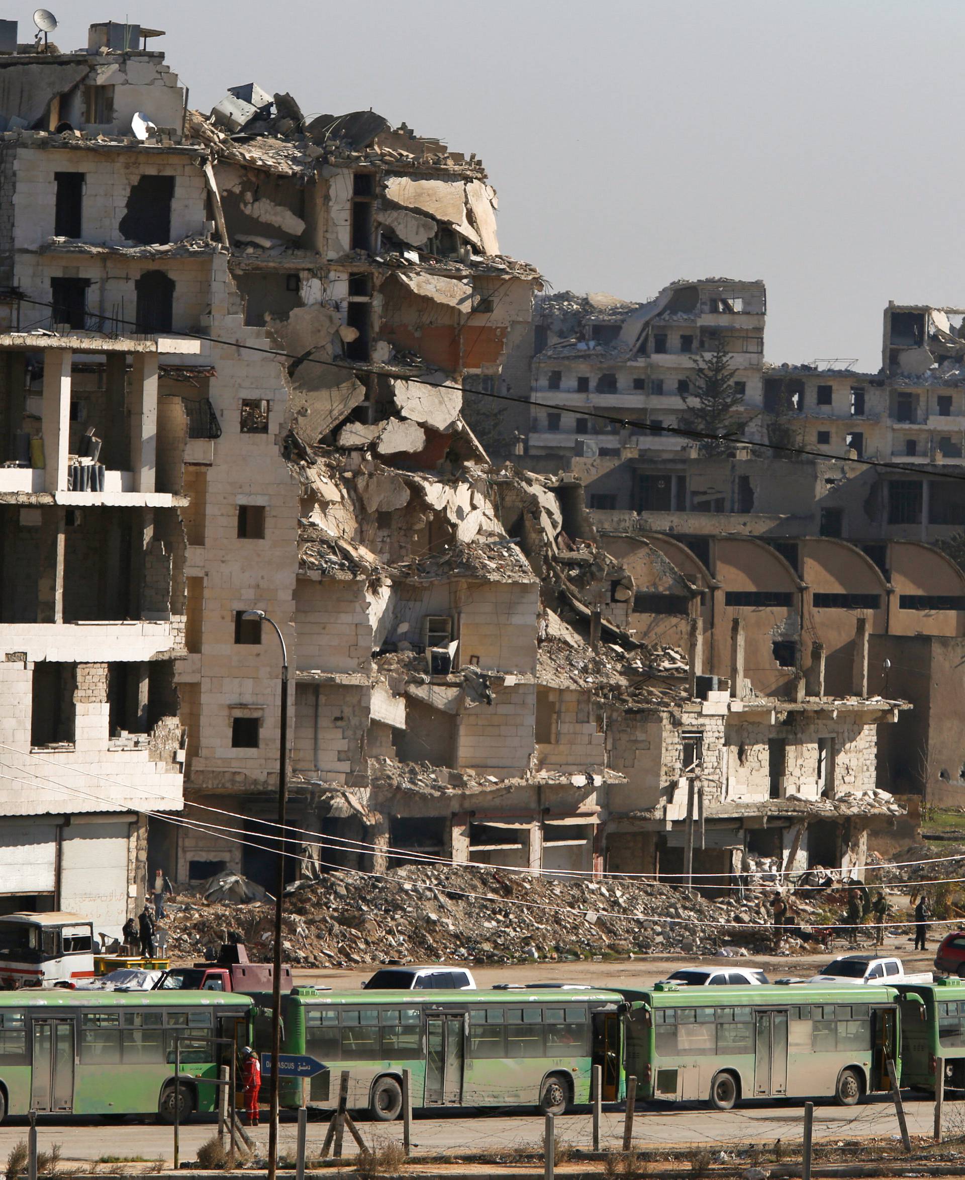 Buses are seen parked in Aleppo's government controlled area of Ramouseh, as they wait to evacuate civilians and rebels from eastern Aleppo