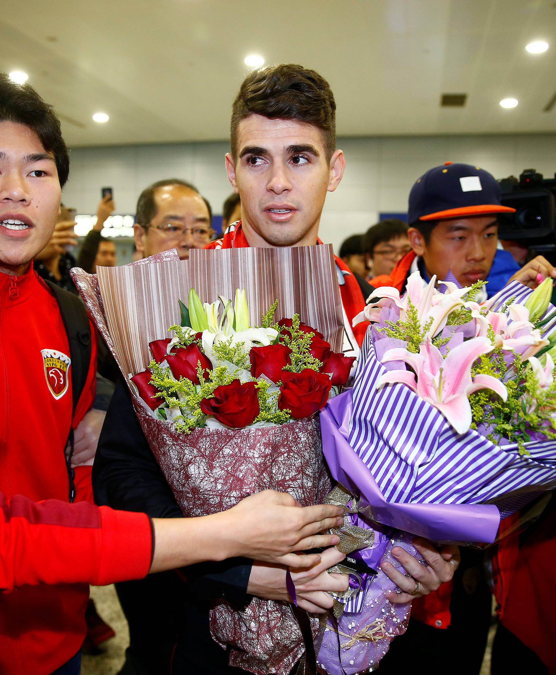 Brazilian international midfielder Oscar arrives at the Shanghai Pudong International Airport, after agreeing to join China super league football club Shanghai SIPG from Chelsea in Shanghai