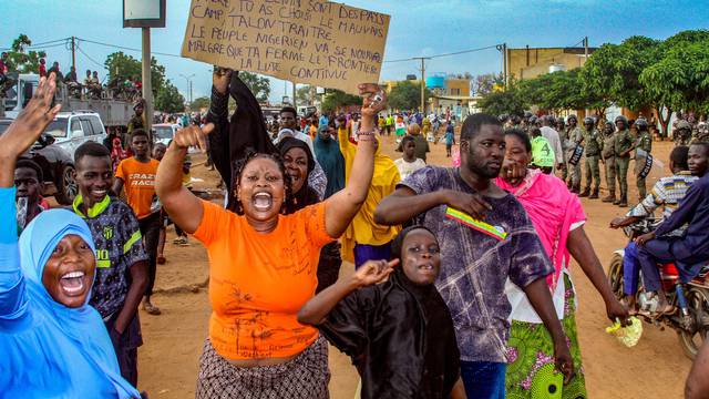 Niger's junta supporters take part in a demonstration in front of a French army base in Niamey,