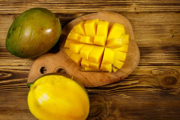 Fresh mango fruit on wooden table
