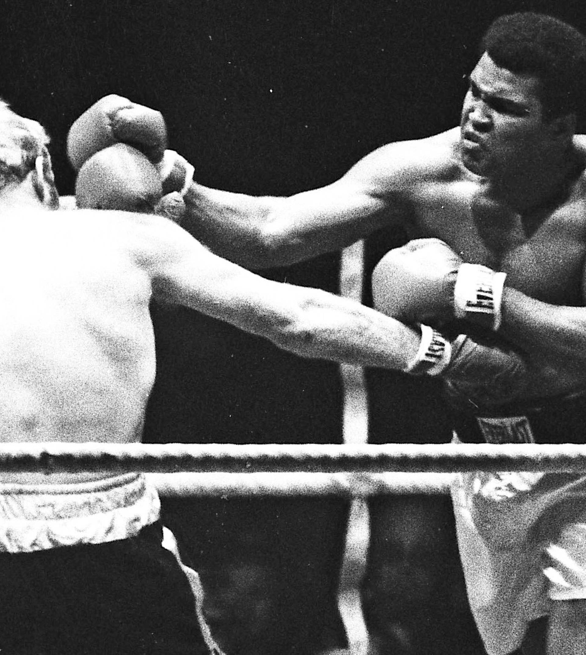 Muhammad Ali punches Richard Dunn while fighting for the WBC & WBA Heavyweight Title in Munich