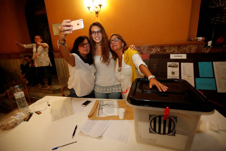  Polling station staff take a selfie as voting ended for the banned independence referendum in Barcelona