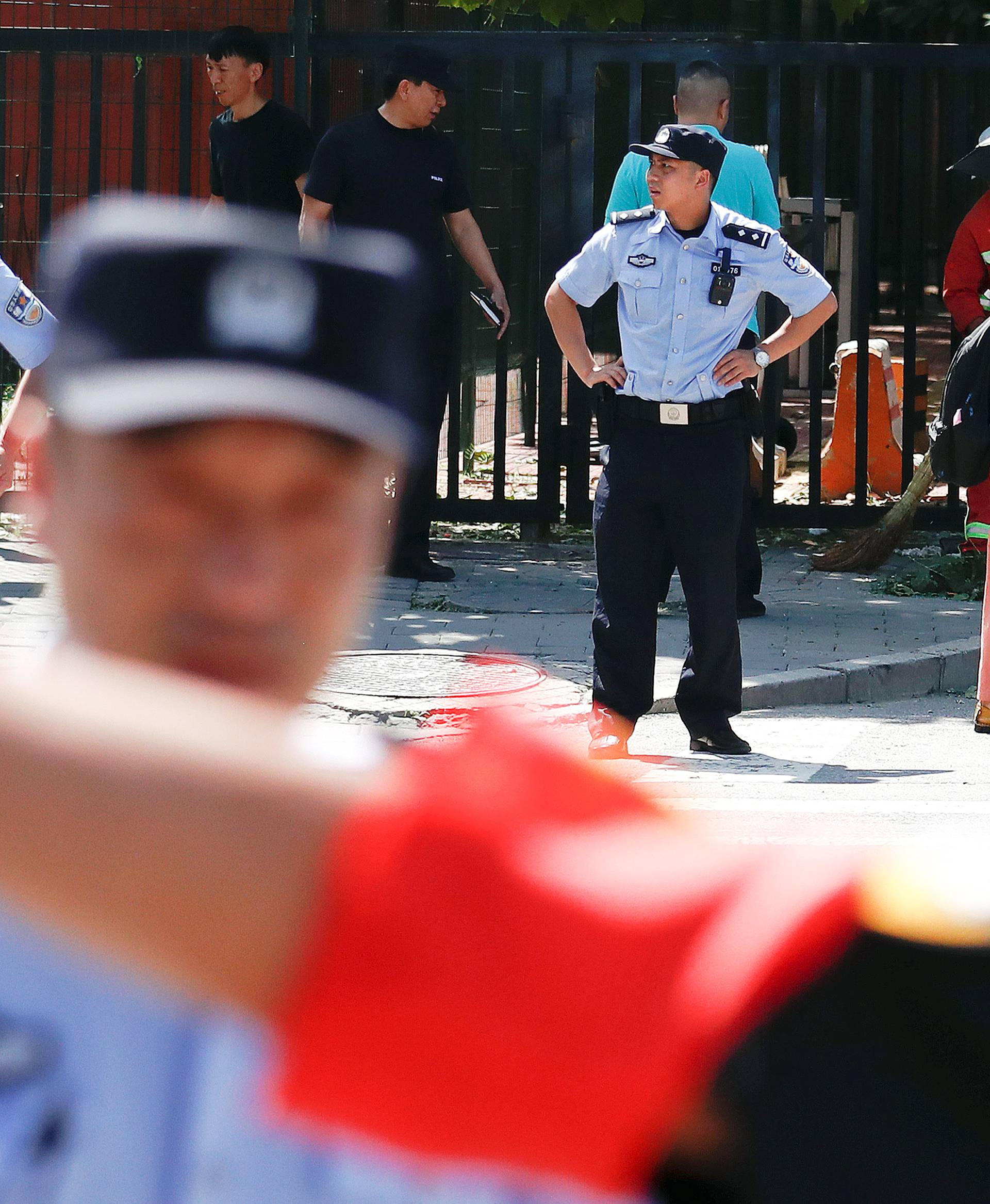 Policemen secure the site of a blast outside the U.S. embassy in Beijing
