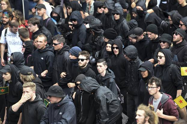 Black Block members walk along other protesters during demonstrations at the G20 summit in Hamburg