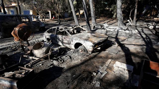 Destroyed cars are seen the day after fires, fanned by strong northern winds known as the mistral, ravaged more than 2,000 hectares of the dry, pine-planted hills north of Marseille