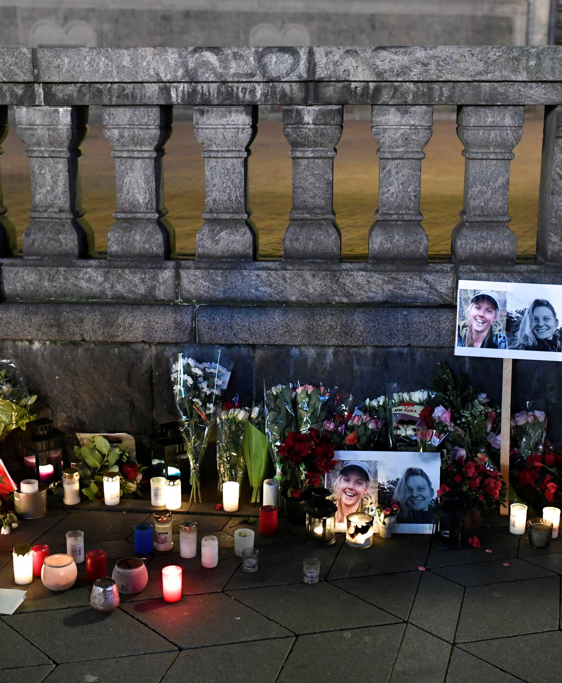 Flowers and candles in memory of Louisa Vesterager Jespersen and Maren Ueland are seen at the Town Hall Square in Copenhagen