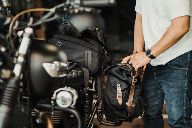 Rider,Install,A,Motorcycle,Saddlebag,Or,Side,Bag,On,Luggage