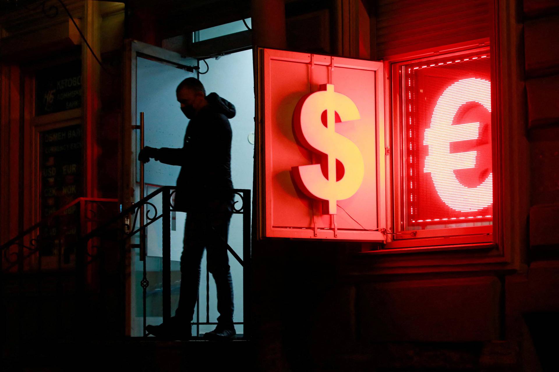 FILE PHOTO: A man walks out of a currency exchange office in Saint Petersburg