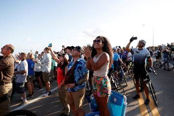 FILE PHOTO: People gather to watch the launch of the Artemis II mission in Titusville