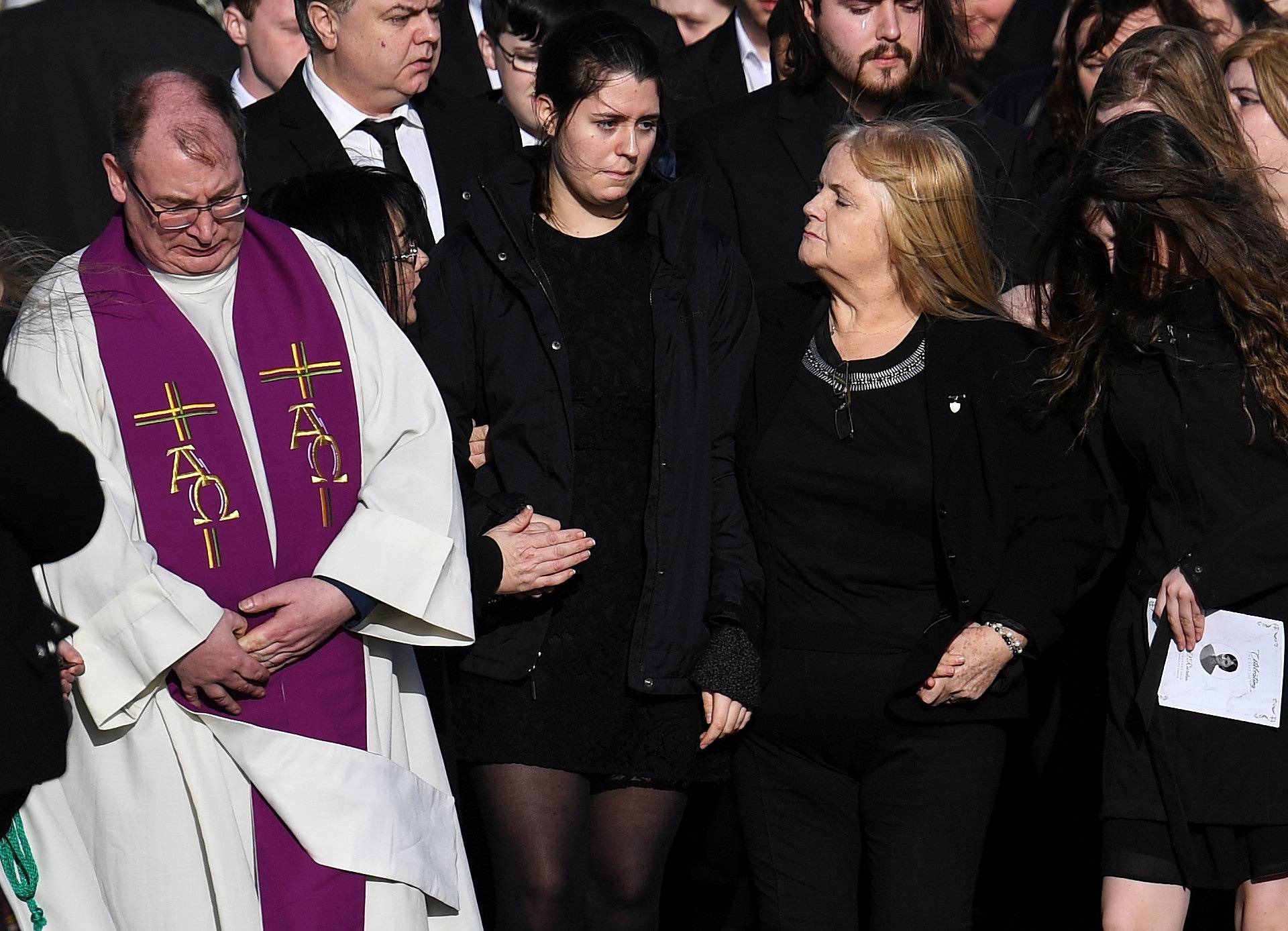 Eillen O'Riordan leaves her daughter Dolores O'Riordan's funeral with one of Dolores' daughters at St Ailbe's Church in Ballybricken