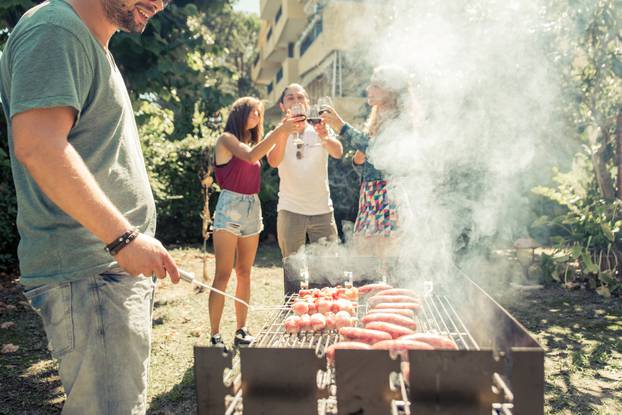 Group,Of,Friends,Making,Barbecue,In,The,Backyard.,Concept,About