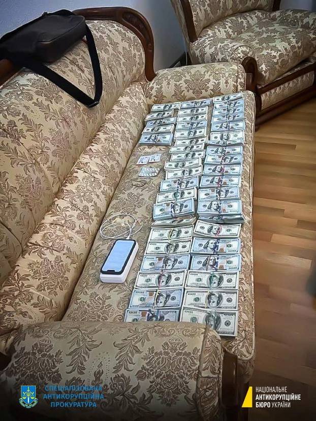 Money found by anti-corruption detectives during investigative actions in a corruption case involving judges of the Supreme Court is depicted in an unknown location in Ukraine