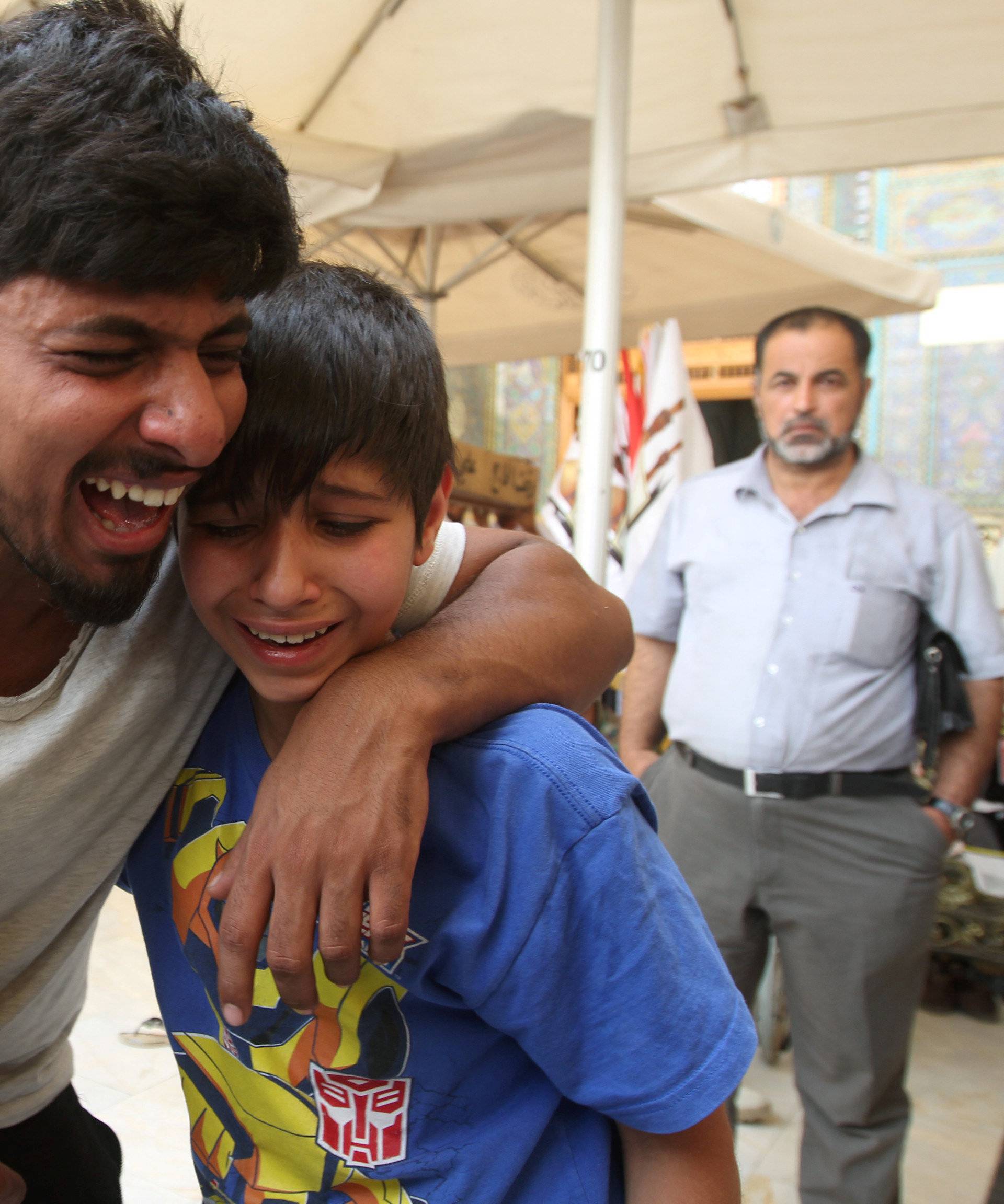 Mourners react during a funeral of a victim who was killed in a suicide car bomb in the Karrada shopping area in Baghdad, during the funeral in Najaf