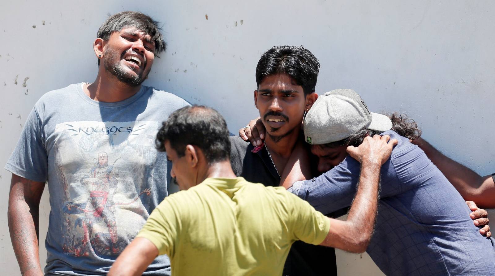 Relatives of a victim of the explosion at St. Anthony's Shrine, Kochchikade church react at the police mortuary in Colombo