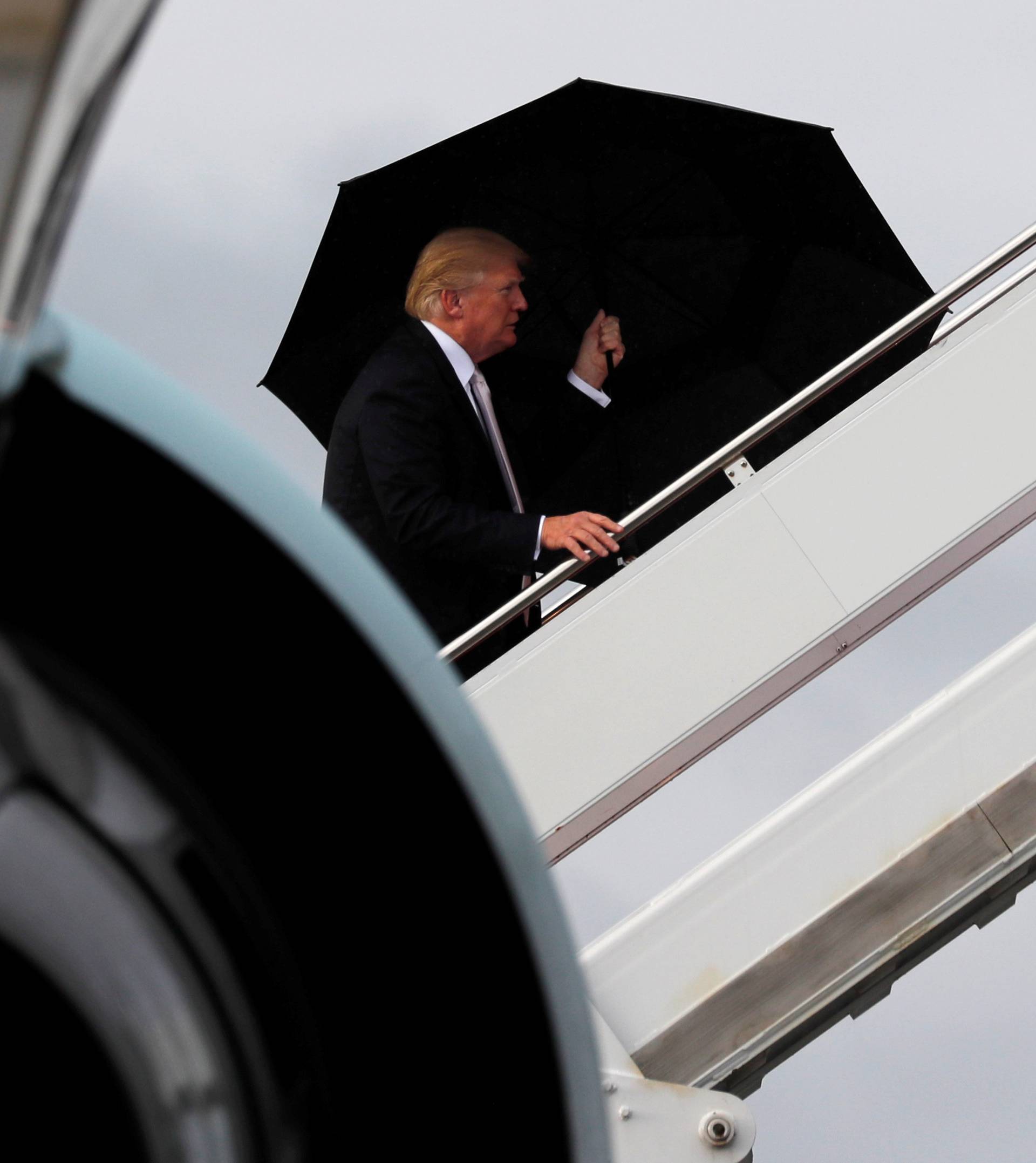 U.S. President Donald Trump boards Air Force One as he departs West Palm Beach