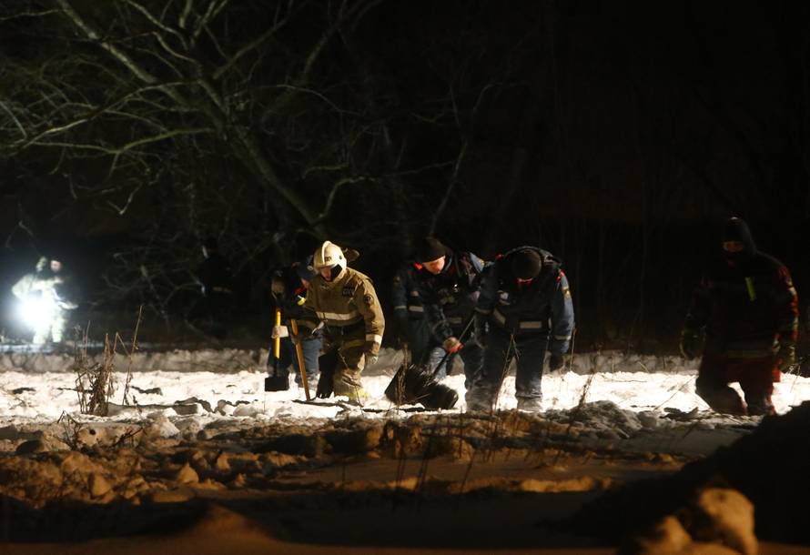 Emergency services work at the scene where a Saratov Airlines Antonov AN-148 plane crashed after taking off from Moscow's Domodedovo airport, outside Moscow