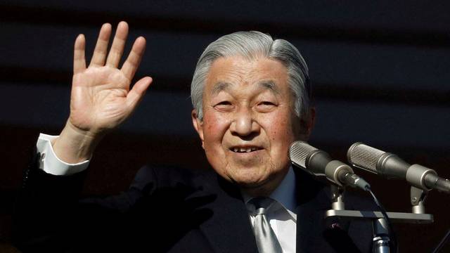 FILE PHOTO: Japan's Emperor Akihito waves to well-wishers during a public appearance for New Year celebrations at the Imperial Palace in Tokyo