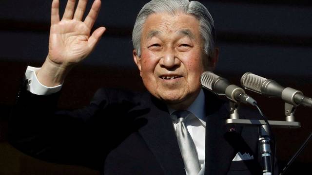 FILE PHOTO: Japan's Emperor Akihito waves to well-wishers during a public appearance for New Year celebrations at the Imperial Palace in Tokyo