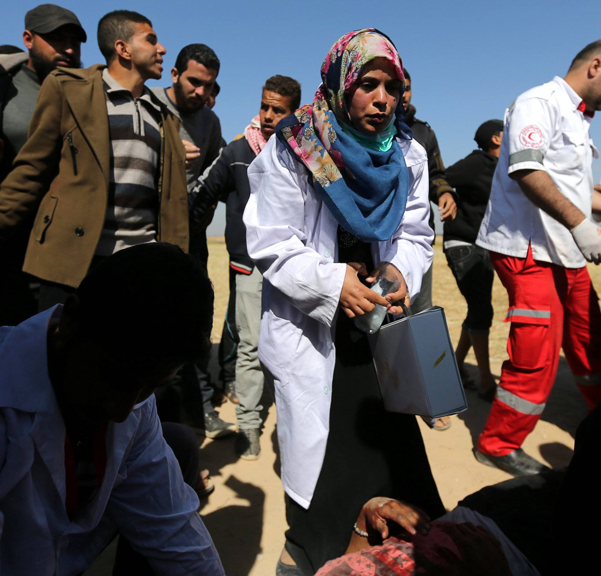 Female Palestinian medic works at the scene of clashes at Israel-Gaza border, in the southern Gaza Strip