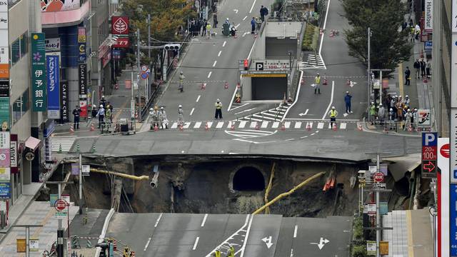 A huge sinkhole is seen at an intersection near Hakata station in Fukuoka, Japan