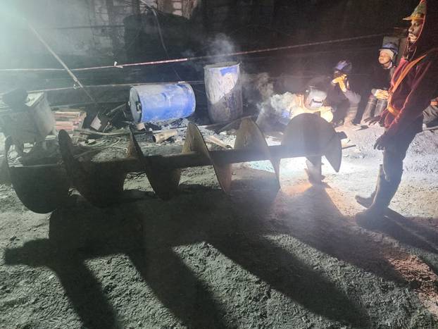 Workers prepare an auger during a rescue operation after a portion of an under-construction tunnel collapsed in Uttarkashi