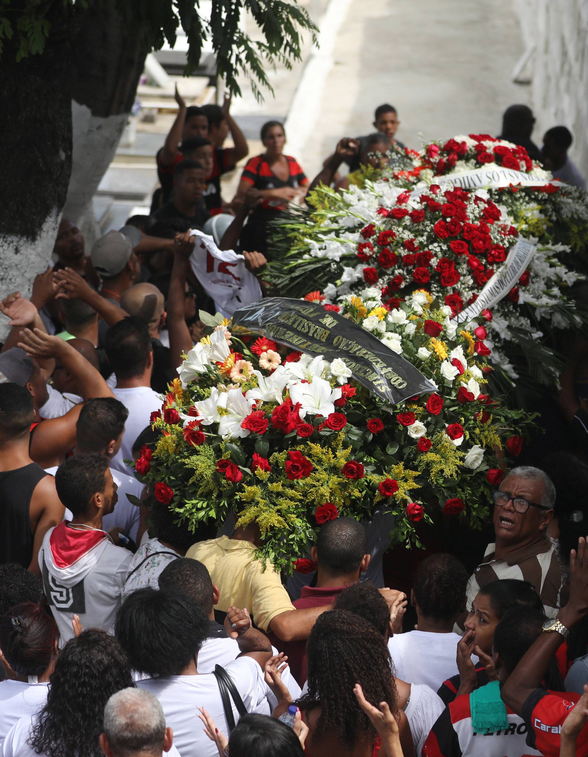 Relatives and friends of teenage soccer player Samuel Thomas de Souza Rosa, who died in the fire that swept through Flamengo's training ground attend his burial, in Rio de Janeiro