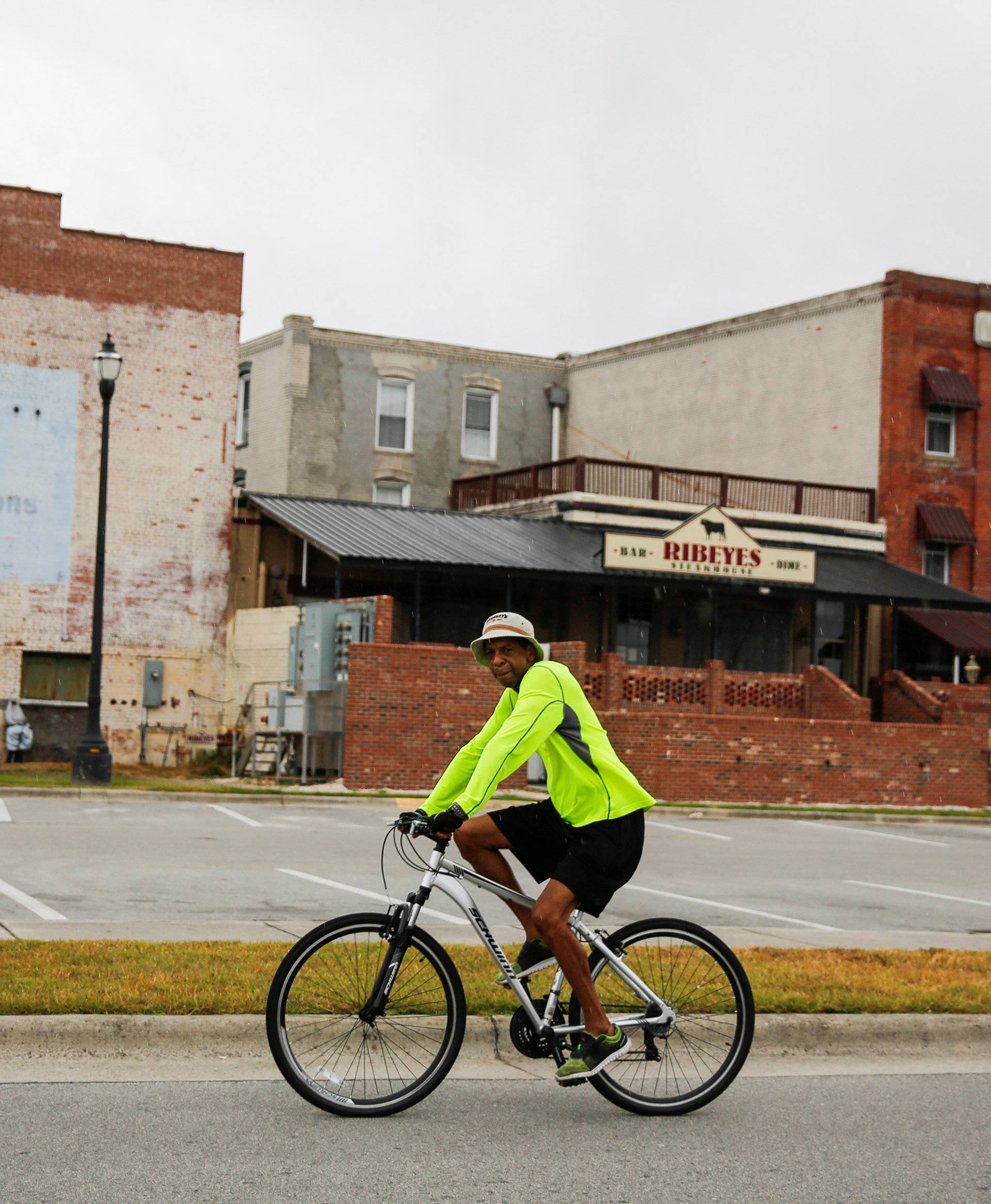 A man rides his bike around the waterfront docks before Hurricane Florence comes ashore in Washington, North Carolina