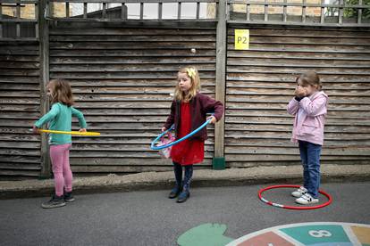 Children use hoops for social distancing at L'Ecole Des Petits school