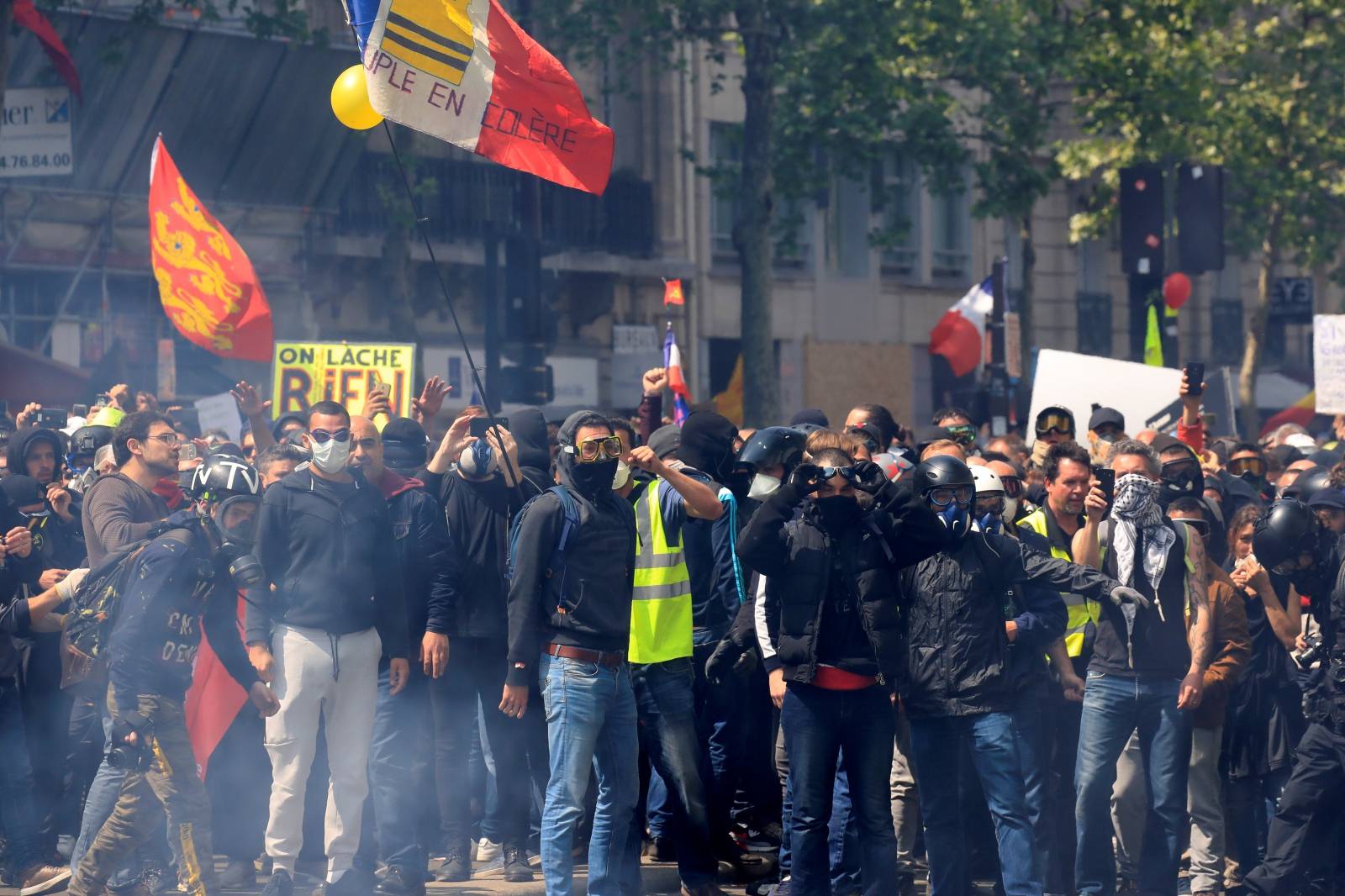 Protesters wearing yellow vests and masked protesters gather before the start of the traditional May Day labour union march in Paris