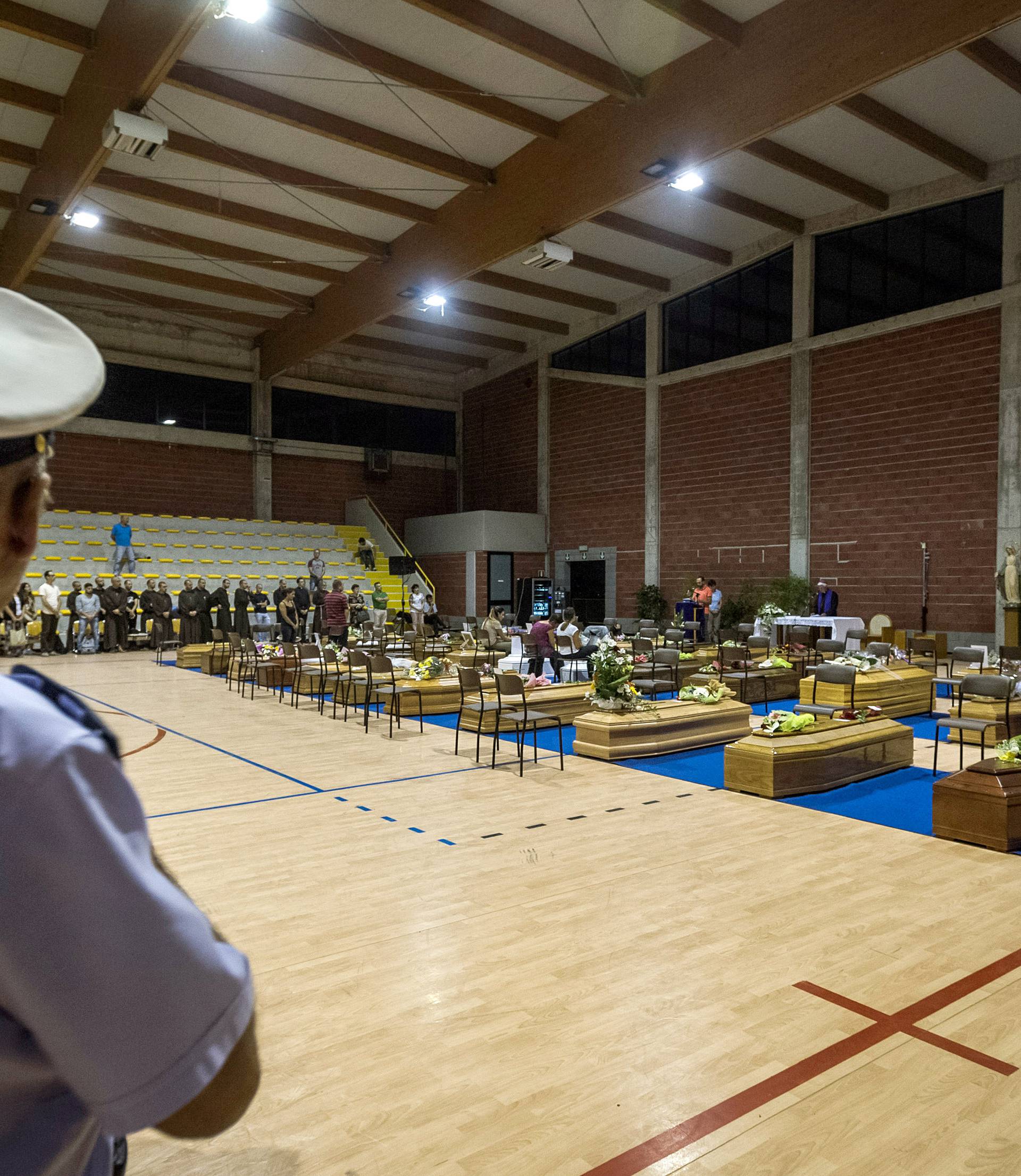 Coffins of some of the victims of the earthquake in central Italy are seen inside a gym in Ascoli Piceno