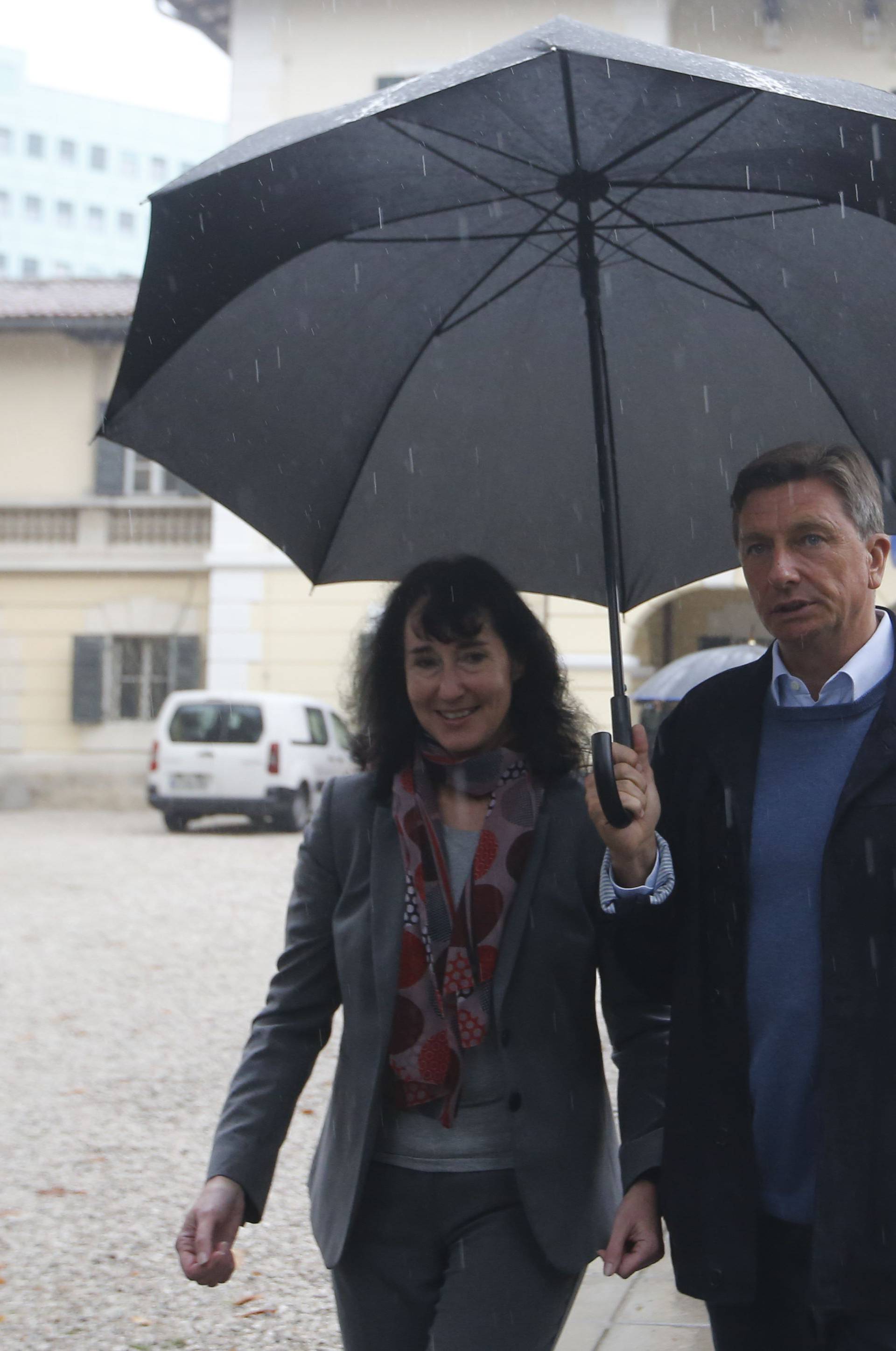 Presidential candidate Borut Pahor and his wife Tanja Pecar walk after casting their votes in the presidential election in Sempeter pri Novi Gorici