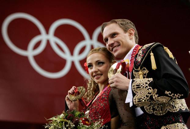 FILE PHOTO: Gold medal winners Tatiana Navka and Roman Kostomarov from Russia pose on the podium after the ice dancing competition at the 2006 Turing Winter Olympics