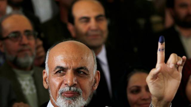 FILE PHOTO: Afghan presidential candidate Ashraf Ghani Ahmadzai holds up his ink-stained finger after voting in the presidential election in Kabul